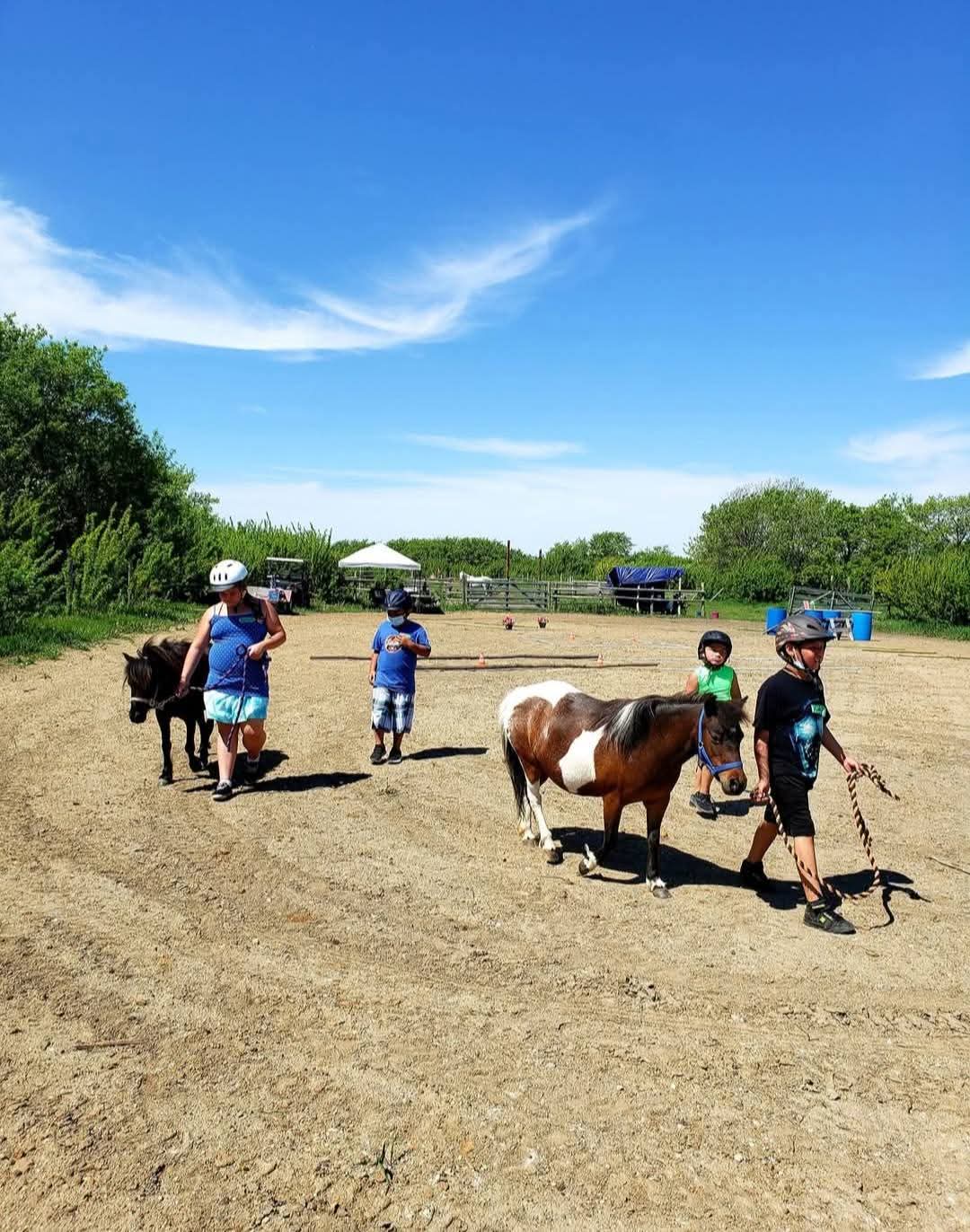 Children and ponies at Spiritstone during a summer day program.